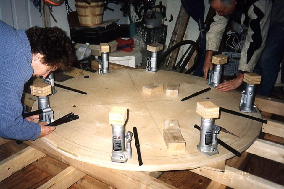 Burlington Taiko members prepare hydraulic jacks on their drum rig